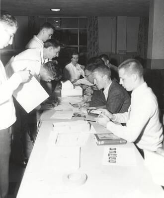 Attendees of the 37th National Convention of the Intercollegiate Knights, a national honorary service organization, gather at the registration table before an event.