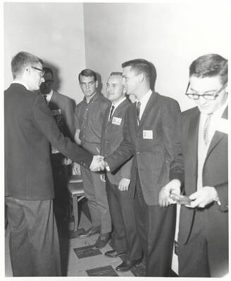 Attendees to the 37th National Convention of the Intercollegiate Knights, a national honorary service organization, network in a hallway.