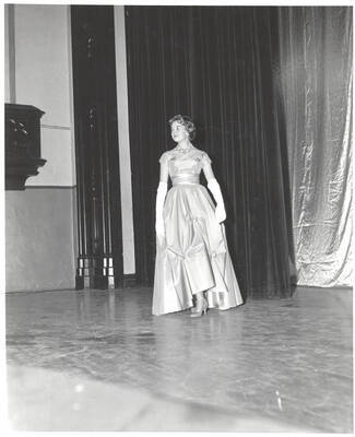 A contestant for queen walks across the Administration Auditorium during the 37th National Convention of the Intercollegiate Knights, a national honorary service organization.