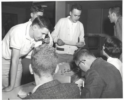 Attendees of the 37th National Convention of the Intercollegiate Knights, a national honorary service organization, gather at the registration table before an event.