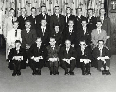 Group picture of Beta Theta Pi. Front Row L-R: Lee Miller, Skip Ward, Lance Johnson, Kent Hove, Danny Langdon, Ron Hunt. Center Row L-R: Arny Skov, J.S.G., Reg Carolan, Mrs. Cummins, Ron Lichau, Pat McQuade, John West. Back Row L-R: Randy Litton, Herb Carlson, Kendall King, Bruce McCowan, Tim Green, Jon Rudy, Don Modie, Bill Stowe, Larry Parberry