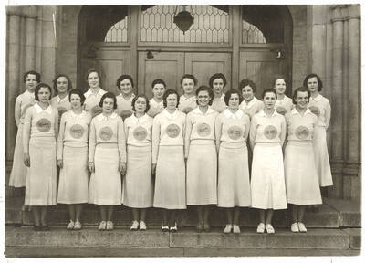 A group photo of the Spurs, a national honorary service organization, standing on the steps of the New Administration Building.