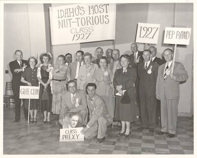 The class of 1927 at their 20th year reunion. University of Idaho President Jesse Buchanan stands in the center. A sign reads 'Idaho's Most Nut-Torious Class, 1927.'