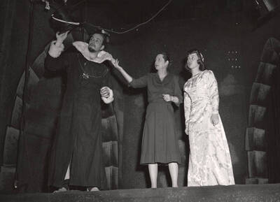 Jean Collette, director, Jack Rudfelt as Claudius, and Joan Coble as Ophelia at rehearsal for the ASUI production of 'Hamlet.' Costumes by Joan Coble (Judy Chavez) in the University Auditorium.