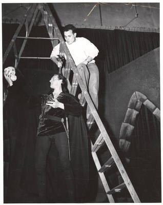 Fred Burton as Hamlet rehearses the famous 'to be or not to be' soliloquy during the ASUI production of 'Hamlet.' Ed Chavez observes from the ladder behind Burton.  Directed by Jean Collette, costumes by Joan Coble (Judy Chavez) in the University Auditorium.
