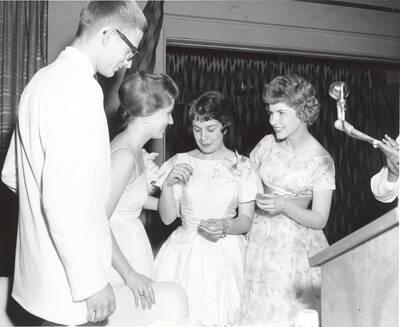 Contestants for queen applaud as the winner is selected during the 37th National Convention of the Intercollegiate Knights, a national honorary service organization.