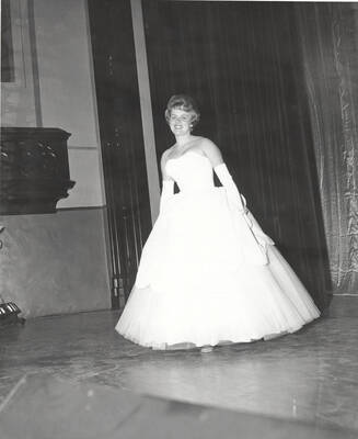 A contestant for queen walks across the Administration Auditorium during the 37th National Convention of the Intercollegiate Knights, a national honorary service organization.