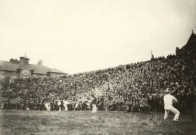 The student cheering section as seen from the endzone during a football game. Yell kings and dukes lead the crowd in a cheer for the home team.
