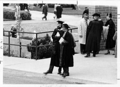 Several faculty members in caps and gowns for the 1971 Commencement. On right, with back to camera, Dr. Alvin Aller. To his right is Dr. Florence D. Aller.