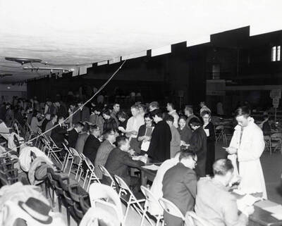 Students double-check schedule cards and discuss options with professors during registration in the Memorial Gymnasium.