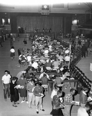 Students sit and sill out schedule cards and wait in class lines during registration in the Memorial Gymnasium. The University reached 4,000 enrolled students this year.