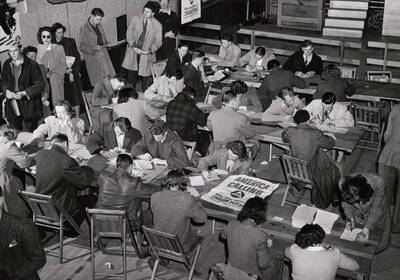 Students fill out schedule cards and request slips during registration in the Memorial Gymnasium.