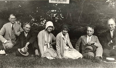 Members of the class of 1901 sit for a photograph in front of the tree they planted in 1900 during  their 30th reunion .