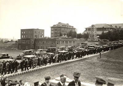 Alumni, faculty, and graduates parade through campus into the Memorial Gymnasium during Commencement.