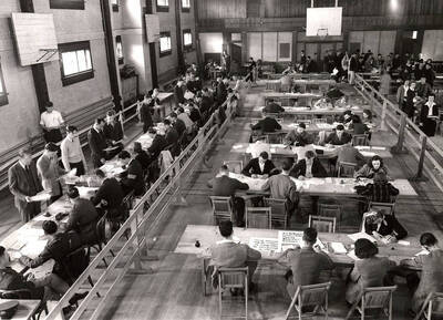 Students fill out course cards and register for courses in the Women's Gym. The Women's Gym became Art and Architecture South in 1976.