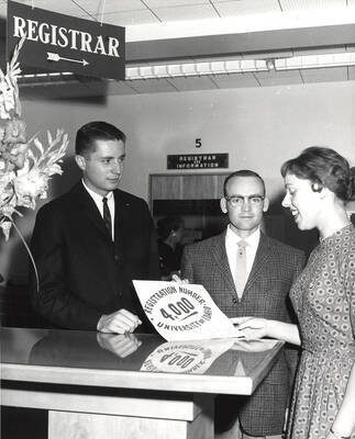 Bruce McCowan and Margaret Tatko congratulate the 4000th student to register. Pictured left to right: Bruce McCowan (ASUI President), ?, Margaret Tatko (AWS President).