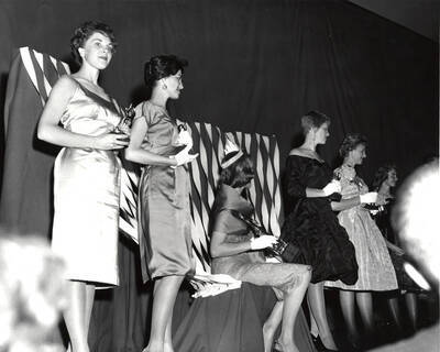 Celeste Jones, Homecoming Queen, and her princesses stand on stage, holding their individual awards.