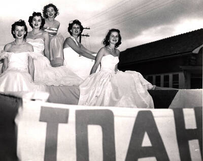 Bea Helander, Homecoming Queen, rides on a float with other Homecoming royalty finalists during the Homecoming parade.
