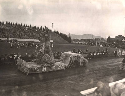 The Delta Gamma winning women's float stands on display during the Homecoming Football game. The text on the float reads 'It's in the Bag'.