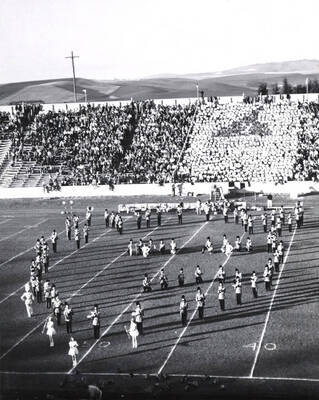 The Vandal Marching Band is caught in a marching set during the halftime performance at a football game.