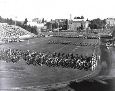 The Vandal Marching Band waits in the endzone for the University of Idaho Military Band to finish their halftime performance.