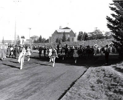 The Vandal Marching Band marches into the stadium behind the Drum Major and Majorettes.