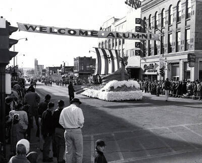 A viking ship with a dragon masthead and an eagle on its sail glides down Main Street in the Homecoming Parade.