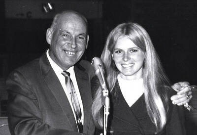 Sally Armstrong, Homecoming queen, and Iver Longeteig, Alumni Association president, pose for a photograph together.