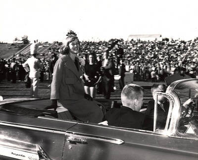 Celeste Jones, Homecoming queen, rides in a car around the football field after being crowned during halftime.