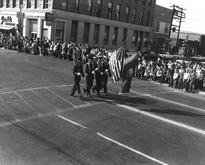 Four members of ROTC Color Guard march in the Homecoming parade.