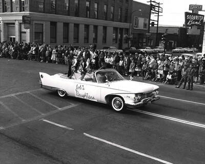 Job's Daughters ride in a car in the Homecoming parade.