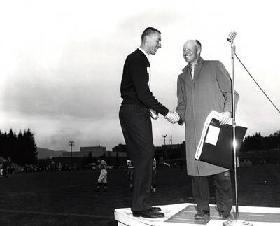 Ken Moren, President of the "I" Club, presents Fred Haltz of Parma an "I" blanket during the Homecoming game.