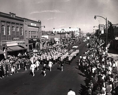 The marching band performs in front of Nuart Theatre, Willis Grocery, Westerns Auto Supply, Moscow Electrical Company and Masonic Temple on Main Street during the Homecoming parade.
