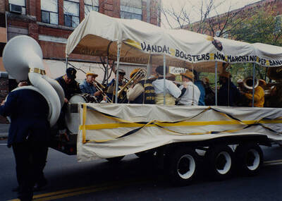 Members of the Vandal Boosters Non-Marching Pep Band play instruments from their float in the Homecoming parade.
