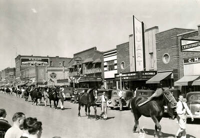 A procession of horses and handlers walking in downtown Moscow as part of the Little International Agriculture Show.