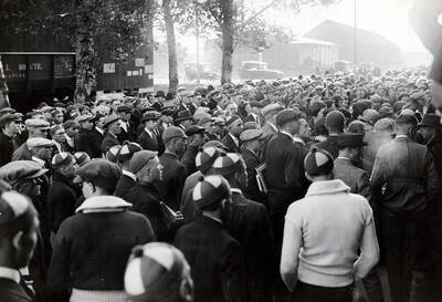 A mass of people surround the Student Special train, some wearing beanies, signifying they are freshman.