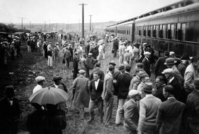 Students stand clustered beside the newly arrived Student Special train.