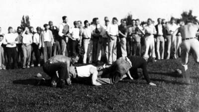 Men grab at each others ankles during the annual freshman-sophomore Hulme fights.