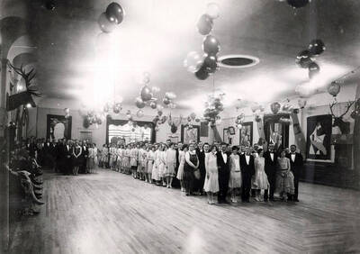 Elk heads line the walls and balloons droop from the ceiling while students participate in the annual march for junior prom.