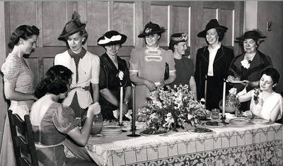Women smile and pour tea during Idaho's Mother's Day weekend.