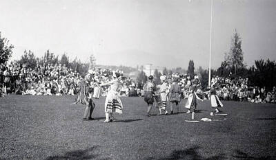 Pairs dressed in traditional Mayday attire perform for students during Idaho's Campus Day celebrations.