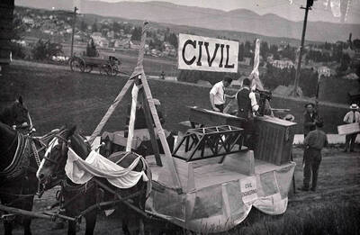 Horses pull the civil engineering float in front of Morrill Hall during Idaho's Campus Day parade.