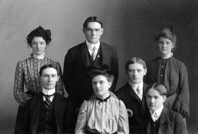 Students pictured: front row: Thomas Jones, Nellie B. Ireton (Editor), Gus Larson, Reginald Leonard. Standing: Zella Perkins, John Shepherd (Business Manager), Margaret Henderson. Staff members for Idaho's Argonaut pose for a picture. From UG50, Library administration Correspondence of Lee Zimmerman-Nellie Ireton Mills file.