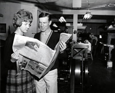 Editor Sharon Lance and sports editor, Herb Hollinger read an issue of the Idaho Argonaut together in the Student Union Building basement.