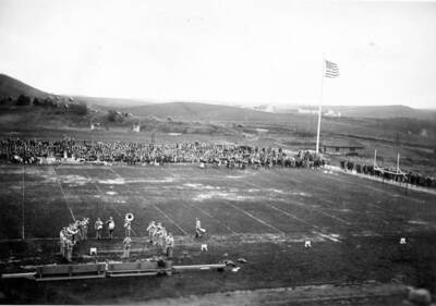 The American flag rises over MacLean Field as the pep band plays a pregame anthem.