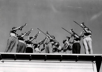 Brass players in the pep band play on a roof. University of Idaho.