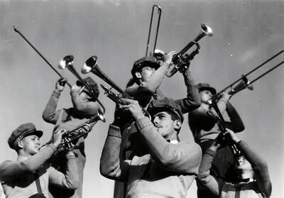 Brass instrument players of the pep band play together.