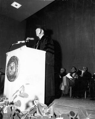 Governor Donald Samuelson stands at the podium giving a speech during University of Idaho's commencement