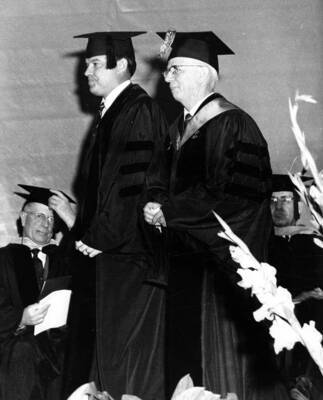 U.S. Senator Frank Church approaches the middle of the stage to receive an honorary Doctorate of Law degree.