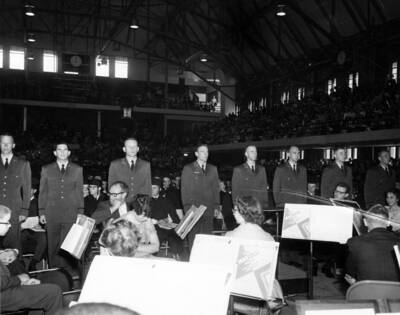 Air Force R.O.T.C. men stand in between the orchestra and students as they are commissioned during University of Idaho's commencement.